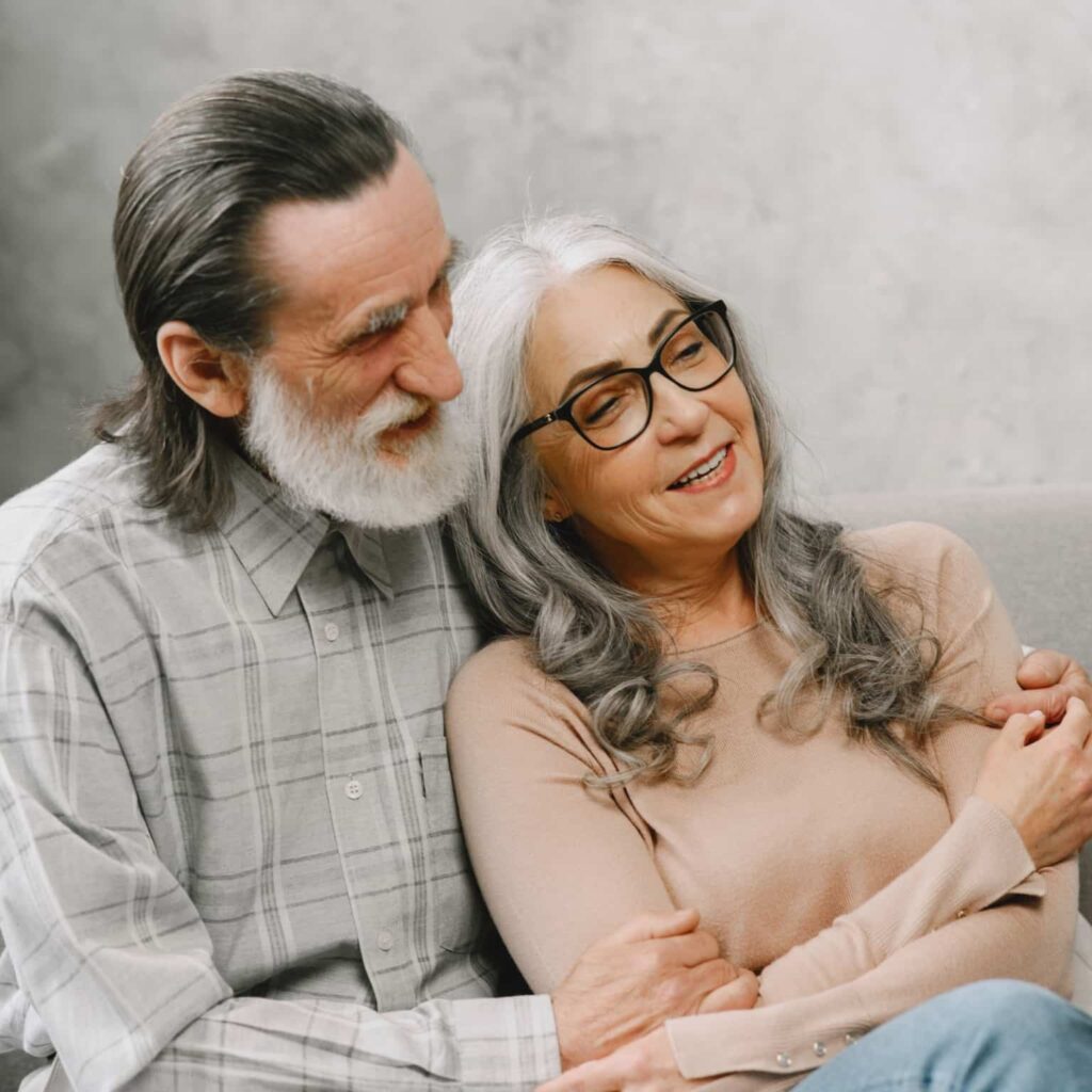 Elderly couple sitting on the couch enjoying incontinence care