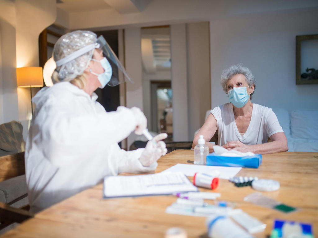 Caregiver Applying Protective Skin Barrier Cream To A Senior Patient'S Leg — senior care guide