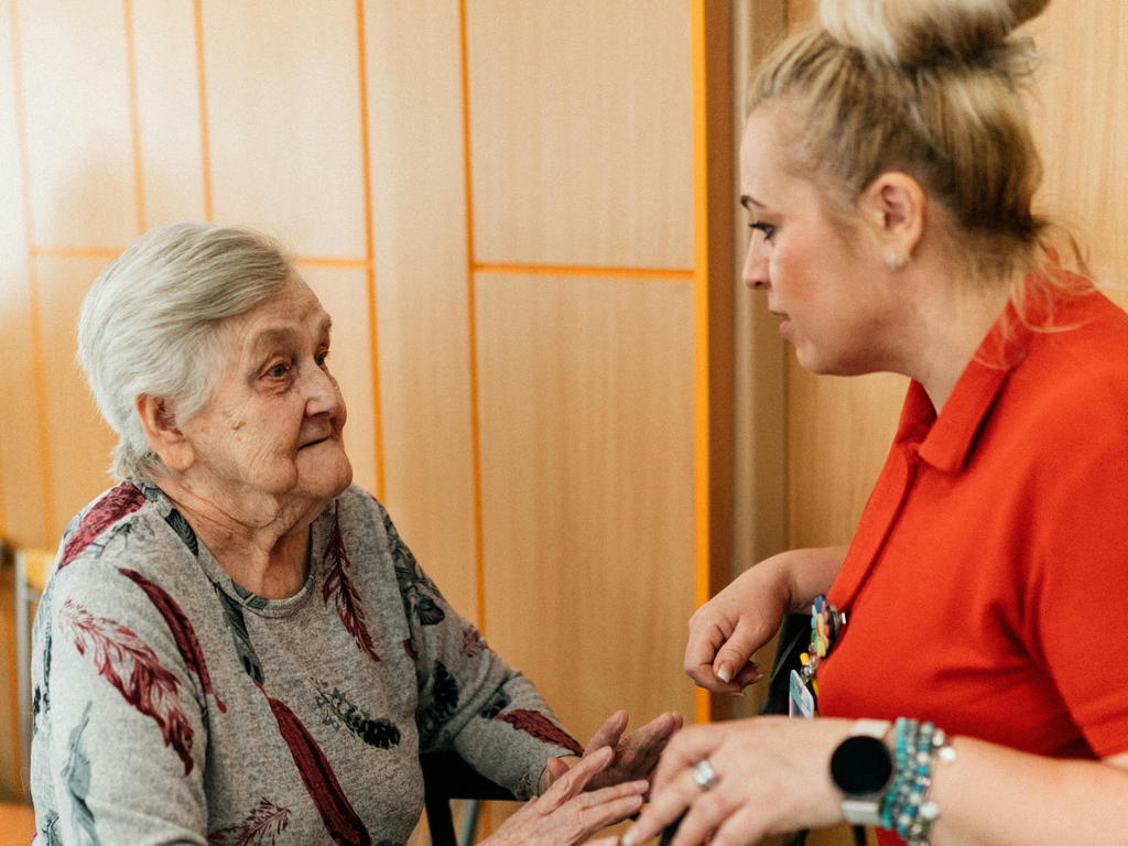 Caregiver Helping Senior Choose Adult Hygiene Products — senior care guide